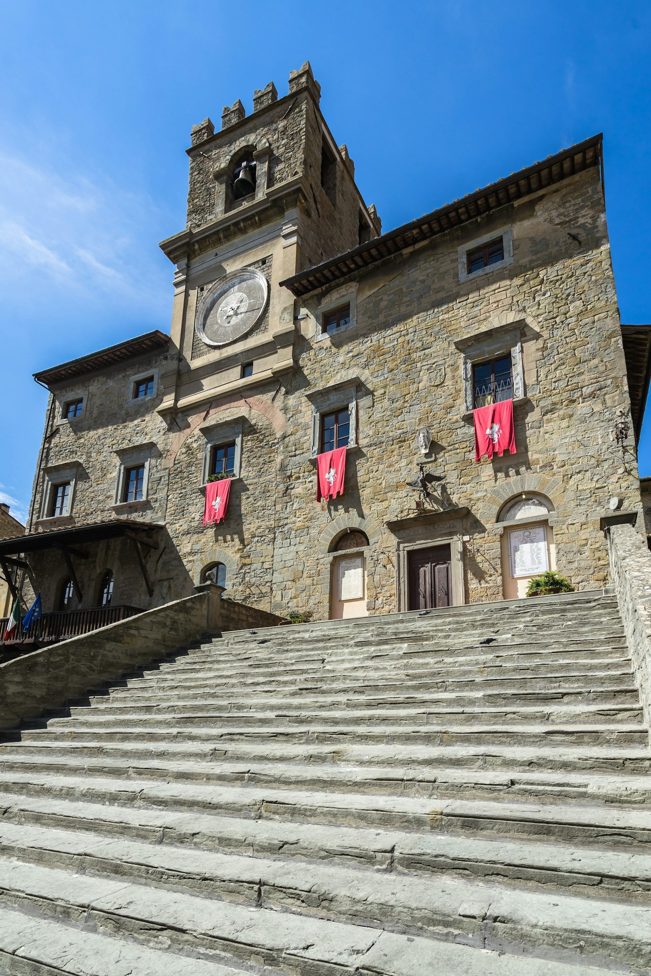Low angle shot of Cortona town hall building in Arezzo province, Tuscany against a blue sky